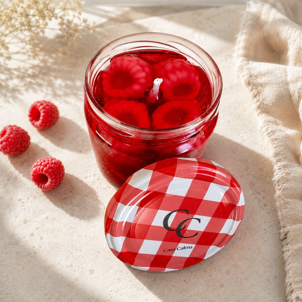 Vista superior de la vela Mermelada de Frutos Rojos de Casa Calma con trozos de cera suspendidos en base translúcida fucsia