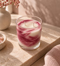 Vela aromática de frutos rojos de Casa Calma, con diseño marmoleado en tonos blancos y rosas.
